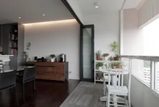 Living room with orange sofa and wooden partition